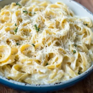 Cottage Cheese Alfredo Sauce topped with herbs in a serving bowl