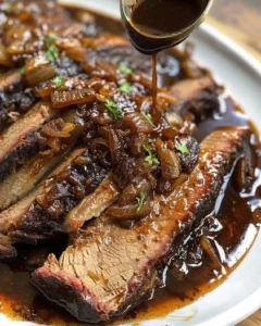Slow cooker brisket served with balsamic onion gravy on a plate